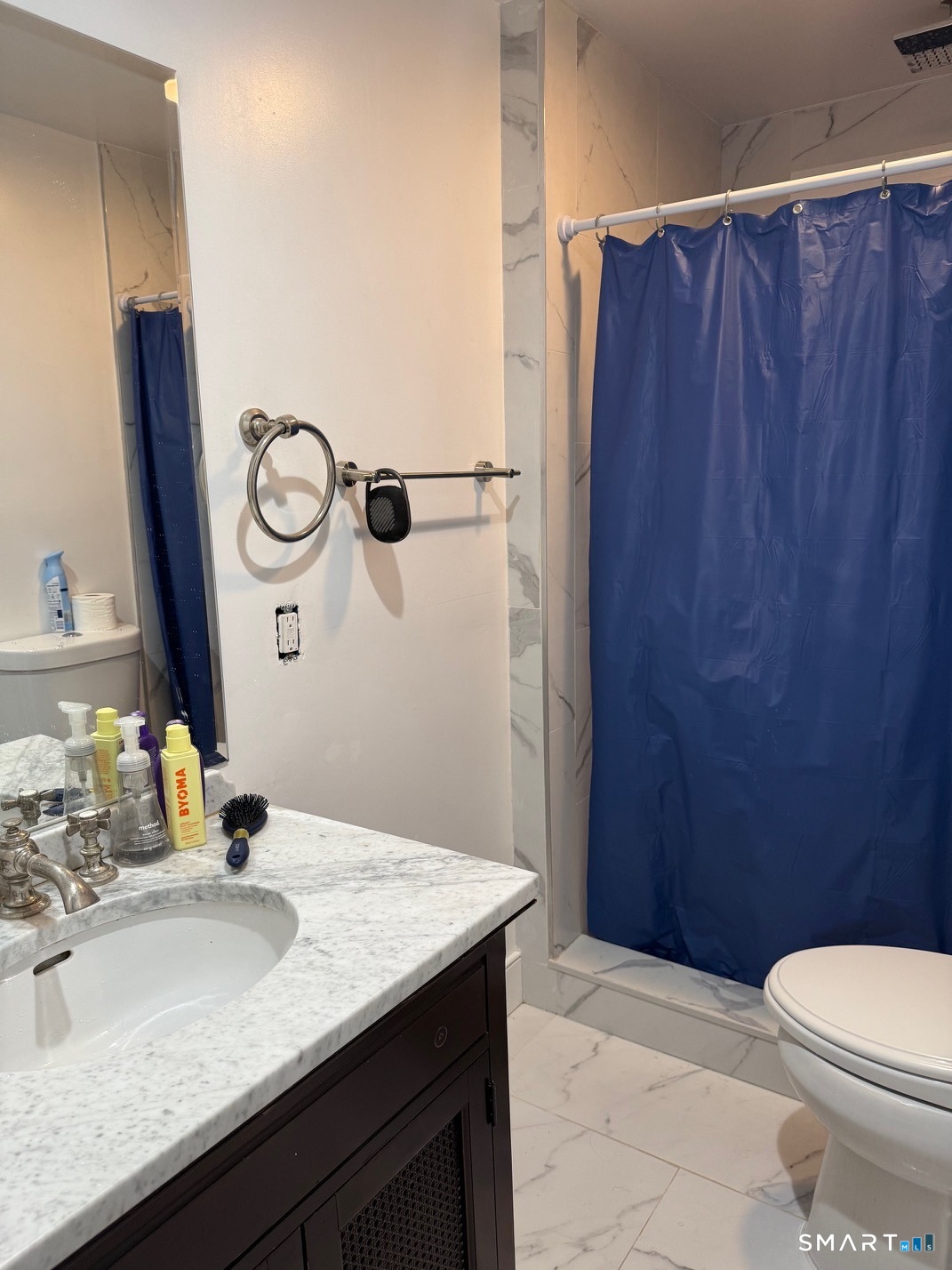 3461 East Main Street Bridgeport, CT 06606 - Photo 26 of 40 a bathroom with a sink a toilet and shower curtain