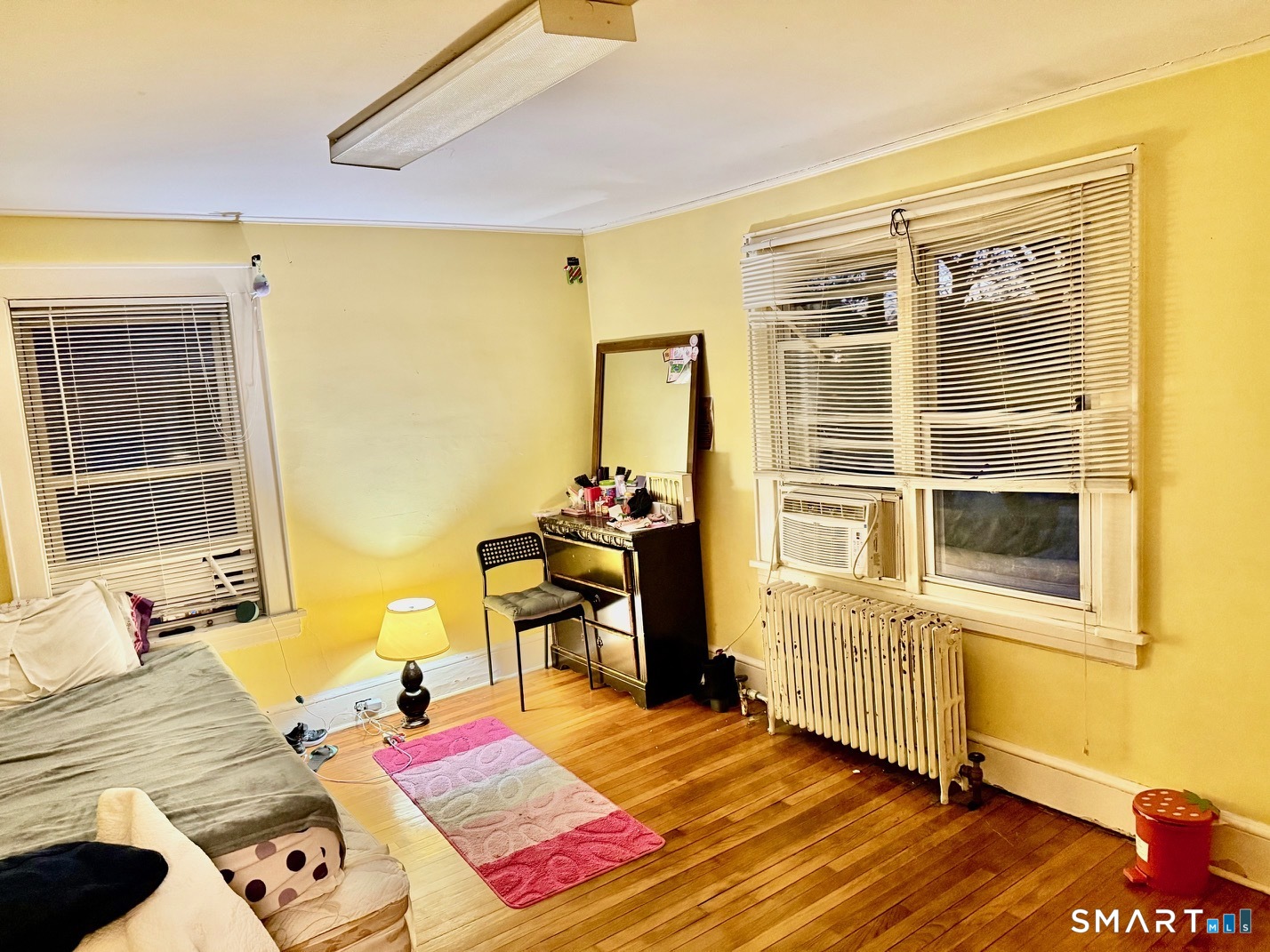 3461 East Main Street Bridgeport, CT 06606 - Photo 32 of 40 a bedroom with a bed and wooden floor