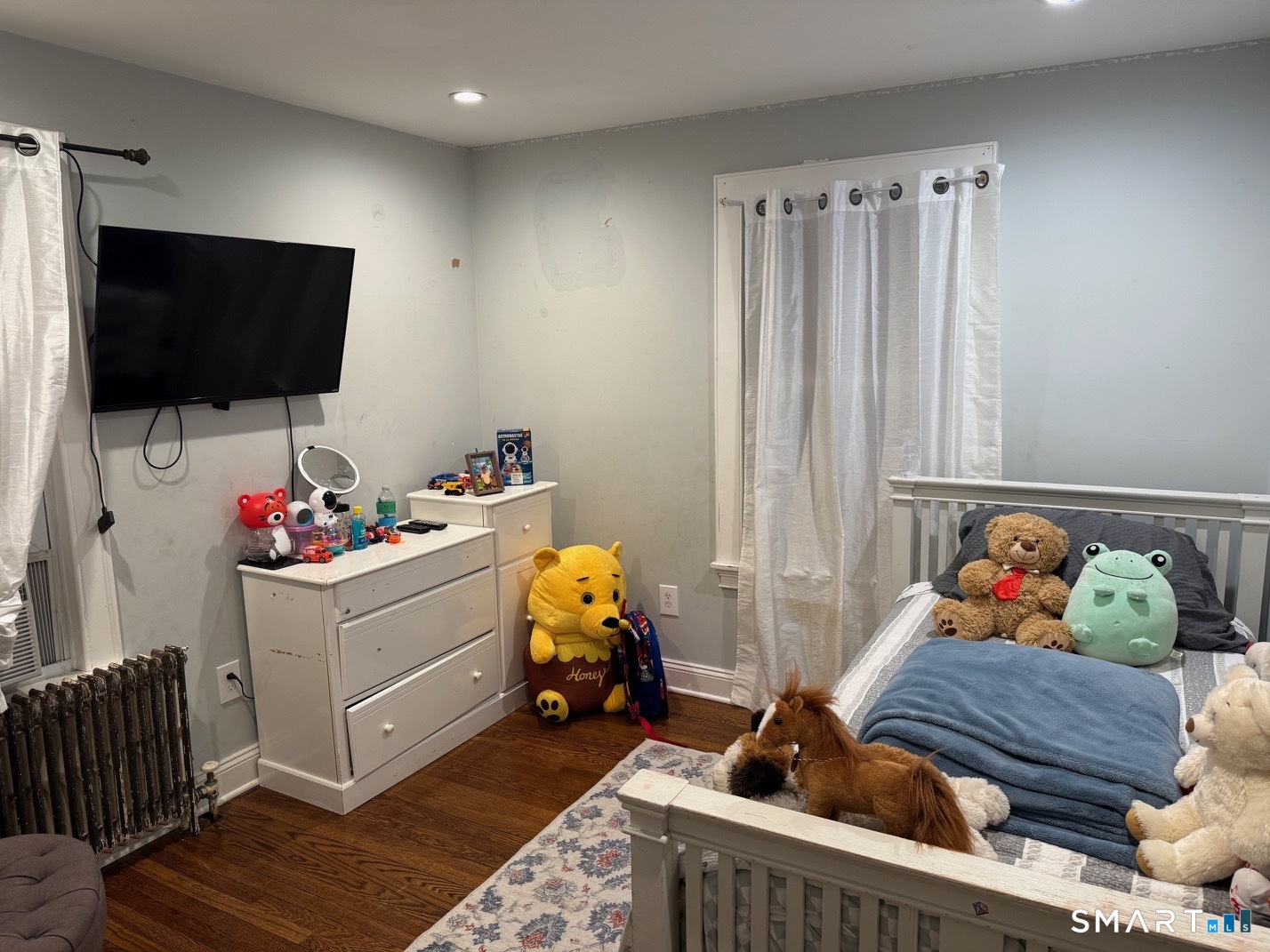 3461 East Main Street Bridgeport, CT 06606 - Photo 33 of 40 a bedroom with furniture and a flat screen tv