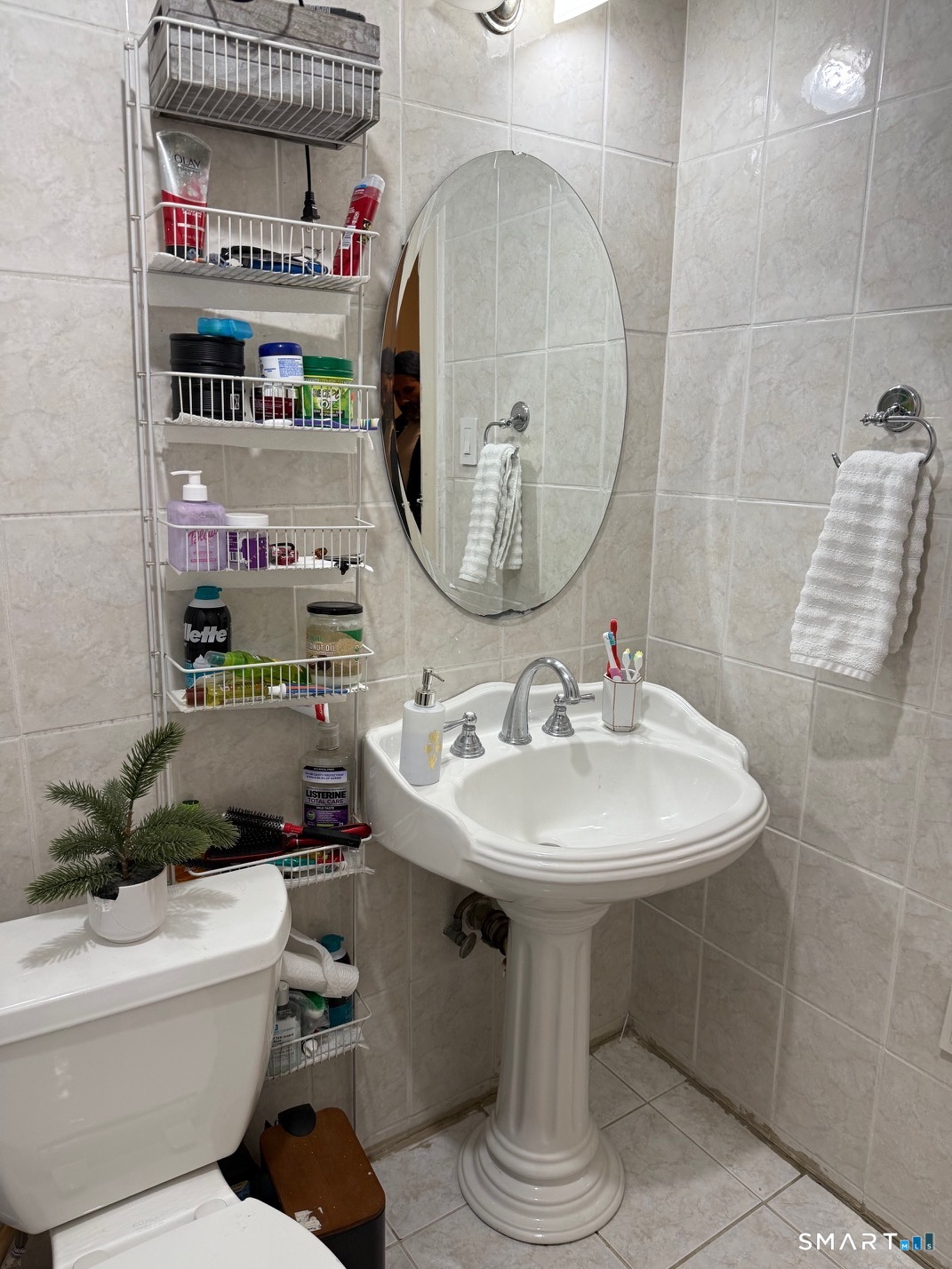 3461 East Main Street Bridgeport, CT 06606 - Photo 40 of 40 a bathroom with a sink a mirror and a toilet