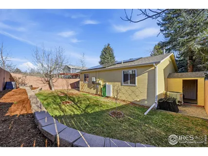 a view of backyard of house with outdoor seating