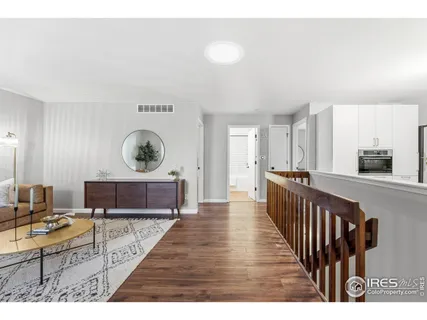 a living room with furniture a rug and a table