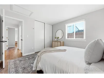 a bedroom with a bed and a night stand