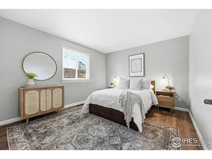 a bed room with a bed mirror and a window