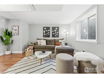 a living room with furniture a window and a potted plant