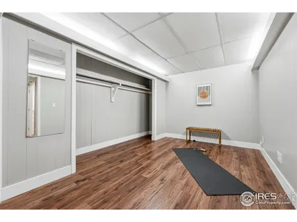 a view of a livingroom with wooden floor and a window
