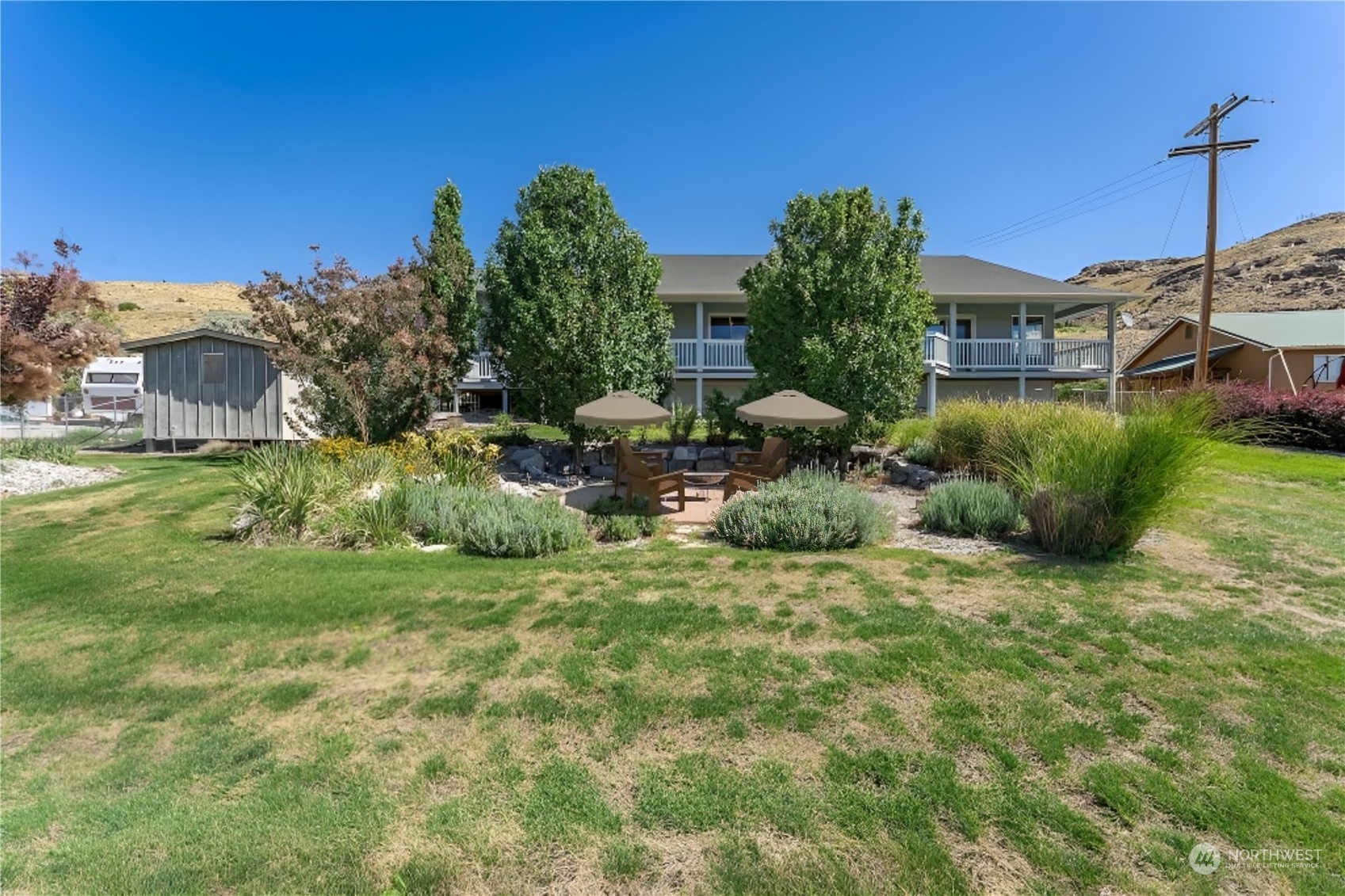 107 Bill Shaw Road Pateros, WA 98846 - Photo 3 of 34 a view of a house with a yard