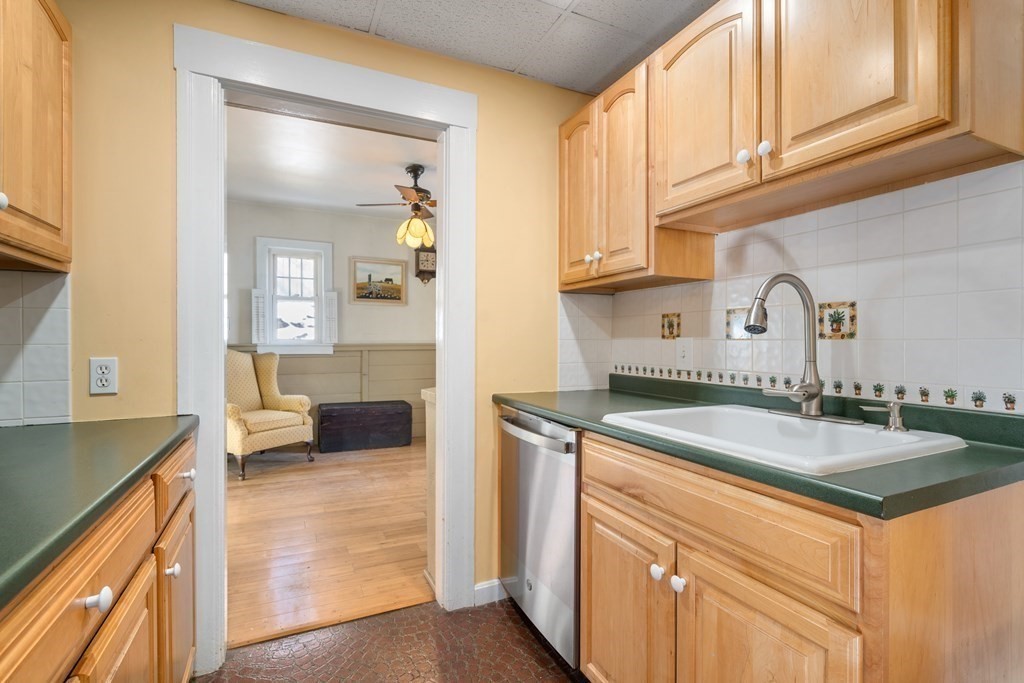 103 Beaconsfield Road Worcester, MA 01602 - Photo 12 of 33 a kitchen with a sink stove and cabinets