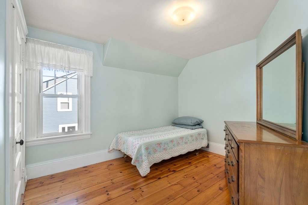 103 Beaconsfield Road Worcester, MA 01602 - Photo 19 of 33 a bedroom with a bed and wooden floor