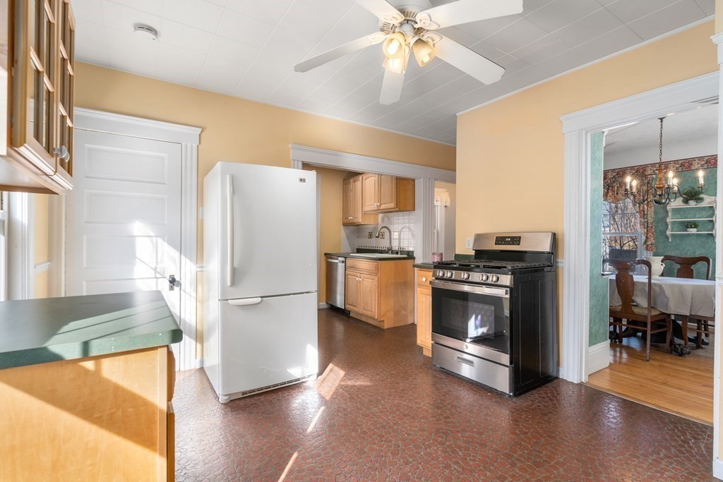 103 Beaconsfield Road Worcester, MA 01602 - Photo 8 of 33 a kitchen with a refrigerator and a stove top oven
