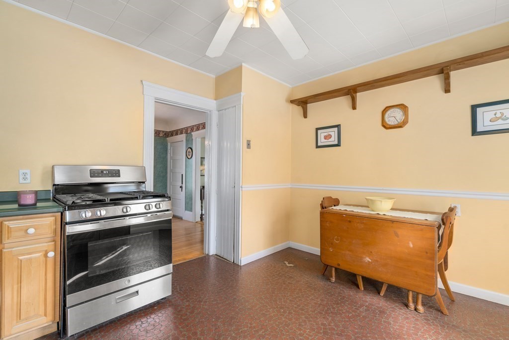 103 Beaconsfield Road Worcester, MA 01602 - Photo 9 of 33 a kitchen with a stove and a refrigerator