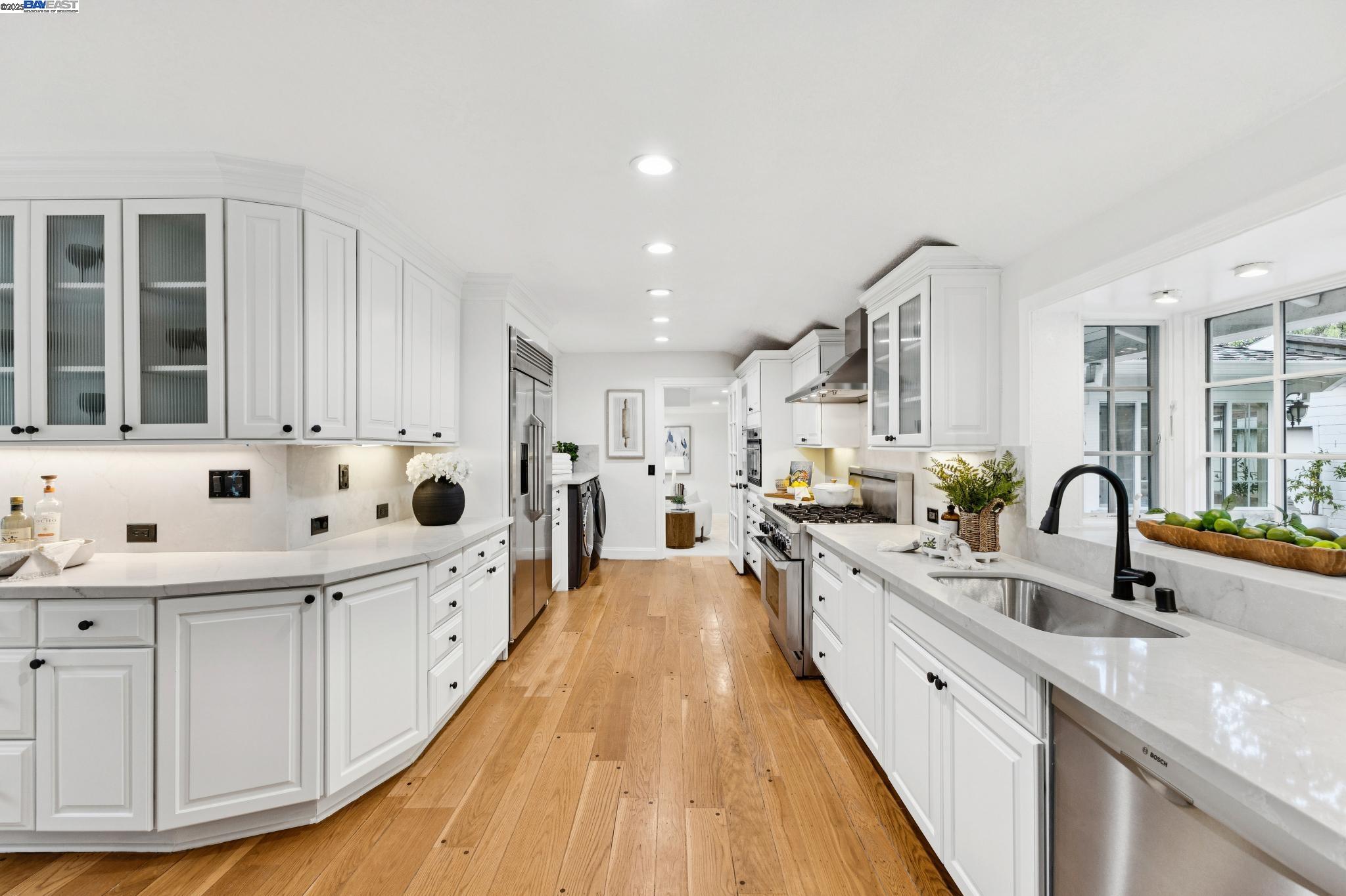 55 Cora Court Walnut Creek, CA 94597 - Photo 14 of 60 a large white kitchen with stainless steel appliances kitchen island a large counter top a sink a stove and a refrigerator