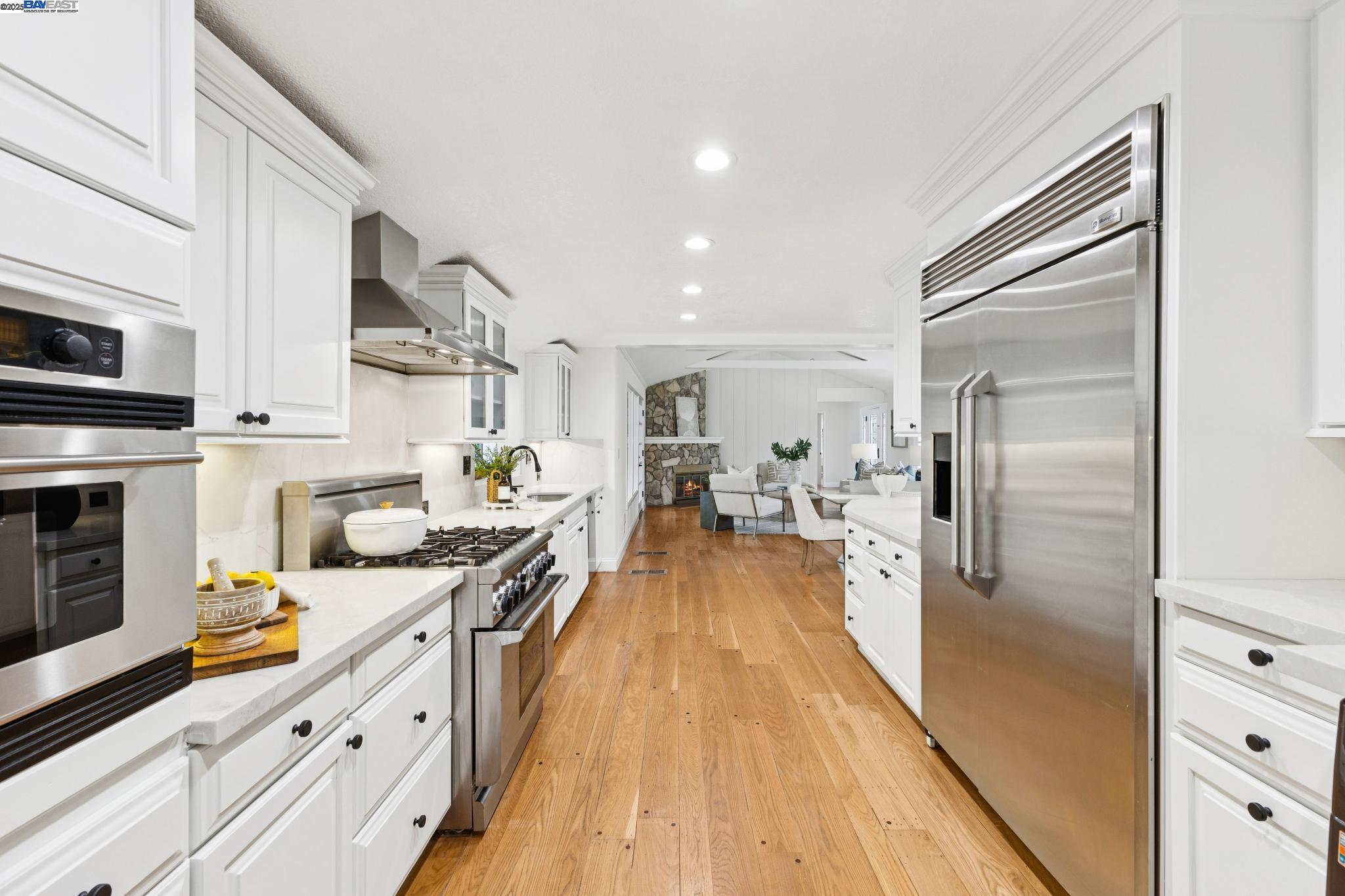 55 Cora Court Walnut Creek, CA 94597 - Photo 16 of 60 a large kitchen with stainless steel appliances granite countertop a lot of counter space and wooden floor