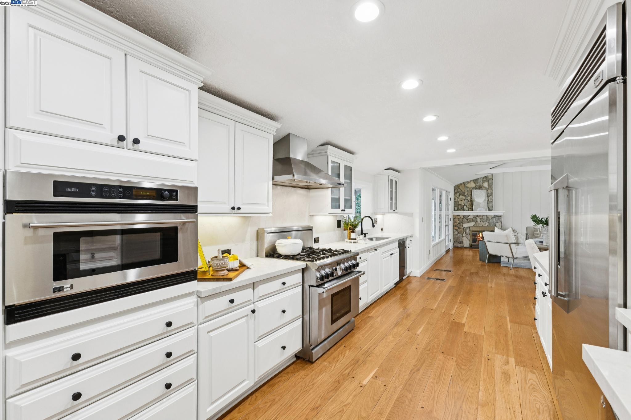 55 Cora Court Walnut Creek, CA 94597 - Photo 17 of 60 a kitchen with white cabinets and stainless steel appliances