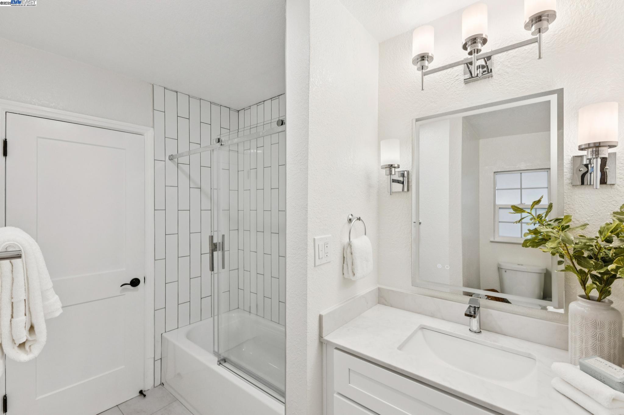 55 Cora Court Walnut Creek, CA 94597 - Photo 31 of 60 a bathroom with a bathtub shower sink and mirror