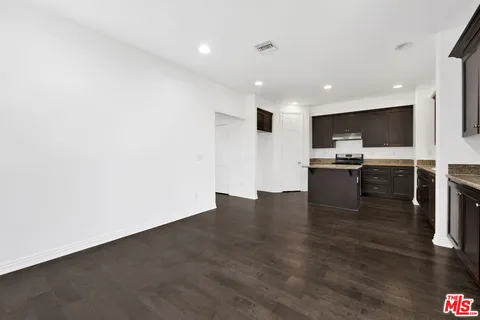 a view of kitchen with microwave oven stove and cabinets