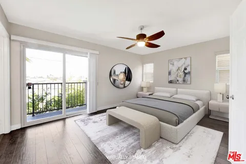 a bedroom with a large bed and a large window