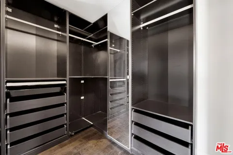 a bathroom with a granite countertop sink a mirror and a shower