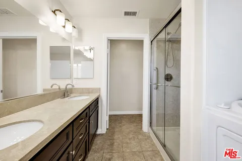 a bedroom with a bed and a potted plant