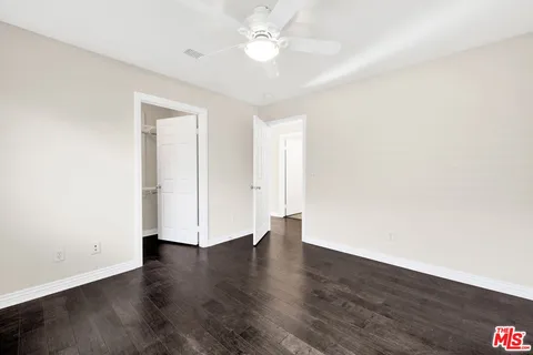 a bathroom with a granite countertop toilet a sink and a mirror