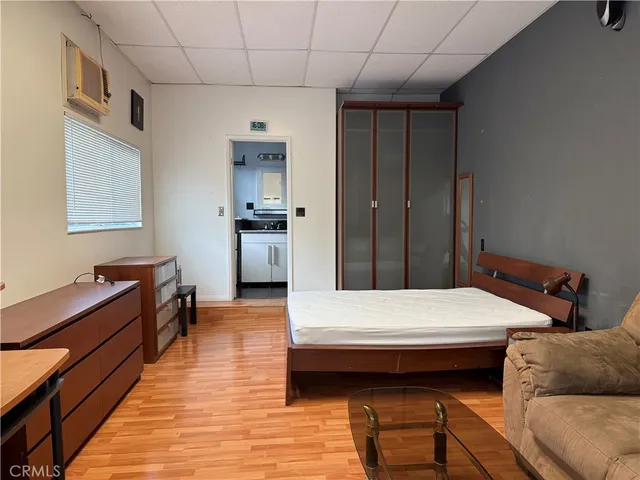 a bedroom with a bed and a dresser