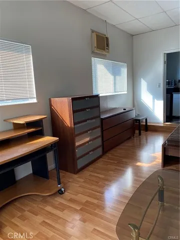 a room with wooden furniture and windows