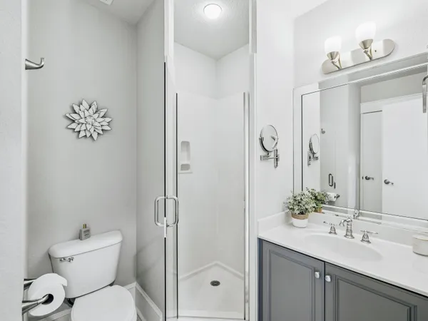 a bathroom with a toilet sink and shower