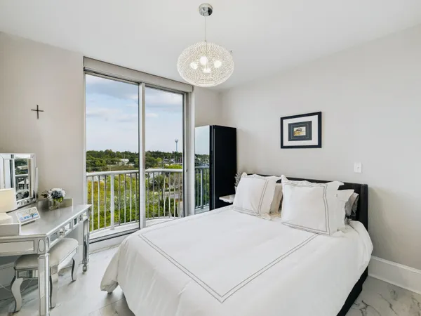 a bedroom with a large bed and a large window