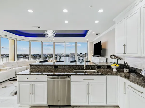 a kitchen with stainless steel appliances granite countertop a stove and a sink