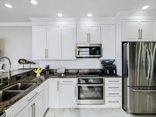 a kitchen with appliances a sink and cabinets
