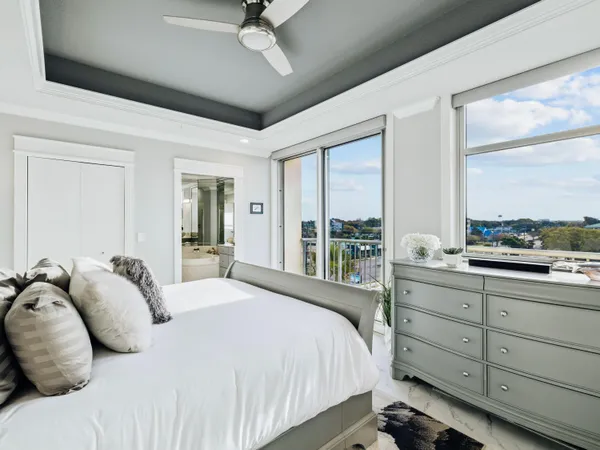 a bedroom with a large bed and a large window