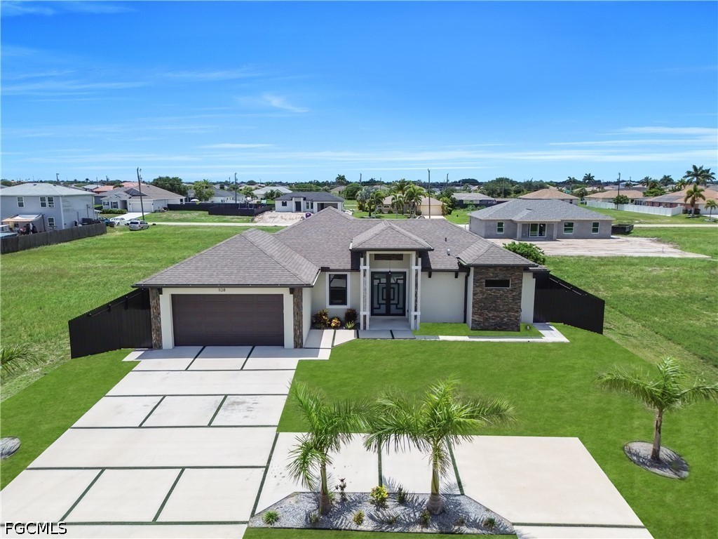 1128 Nelson Road North Cape Coral, FL 33993 - Photo 1 of 22 a view of a house with a garden and yard