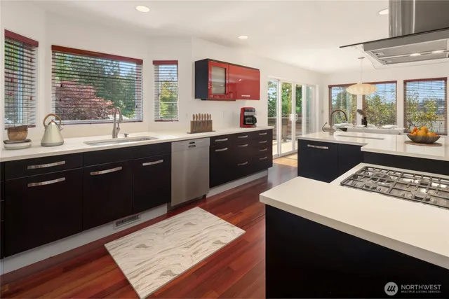 a kitchen with a sink stove and wooden cabinets