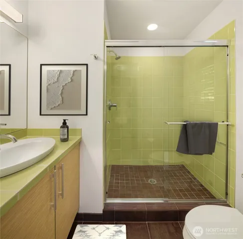 a bathroom with a granite countertop sink toilet and shower