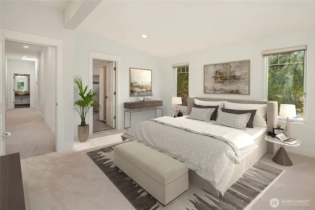 a bedroom with a large bed and a potted plant