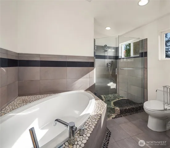 a bathroom with a bathtub and toilet