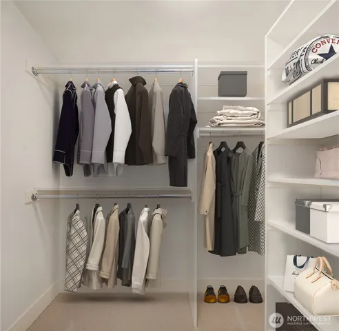 a view of walk in closet with clothes and shoes