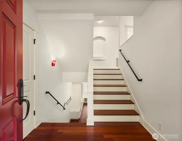 a view of entryway and hall with wooden floor
