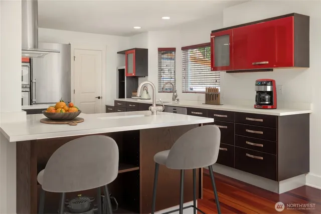 a kitchen with a table chairs sink and cabinets