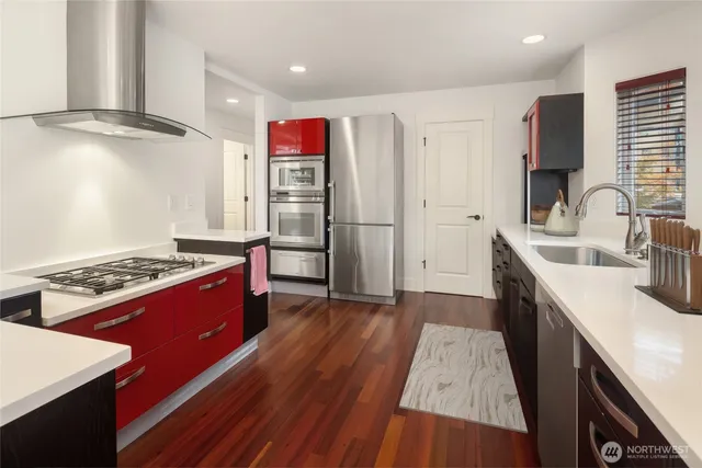 a kitchen with stainless steel appliances granite countertop a sink stove and refrigerator