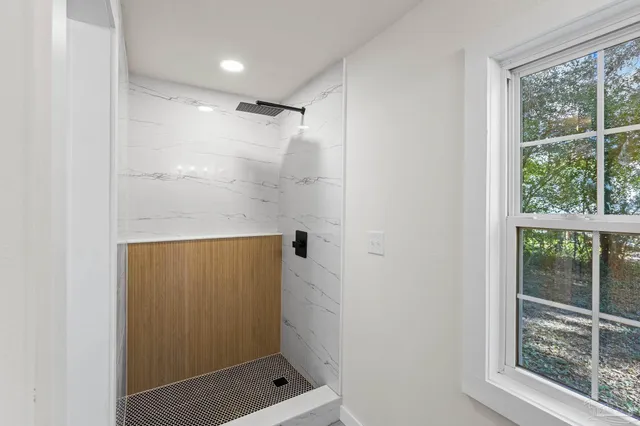 a bathroom with a shower and a window