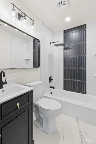 a bathroom with a sink toilet a mirror and shower