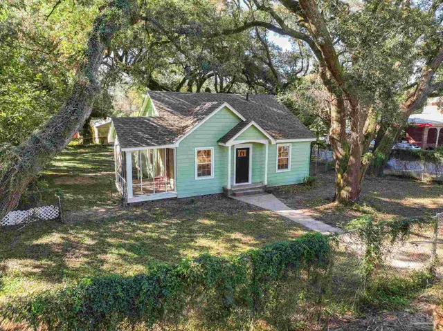 a house with green field in front of it