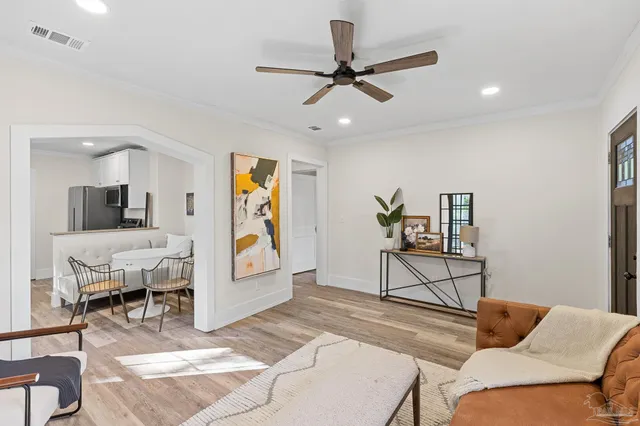 a living room with furniture and kitchen view