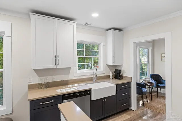 a kitchen with a stove a sink and a window