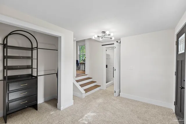 a view of a refrigerator in kitchen and empty room