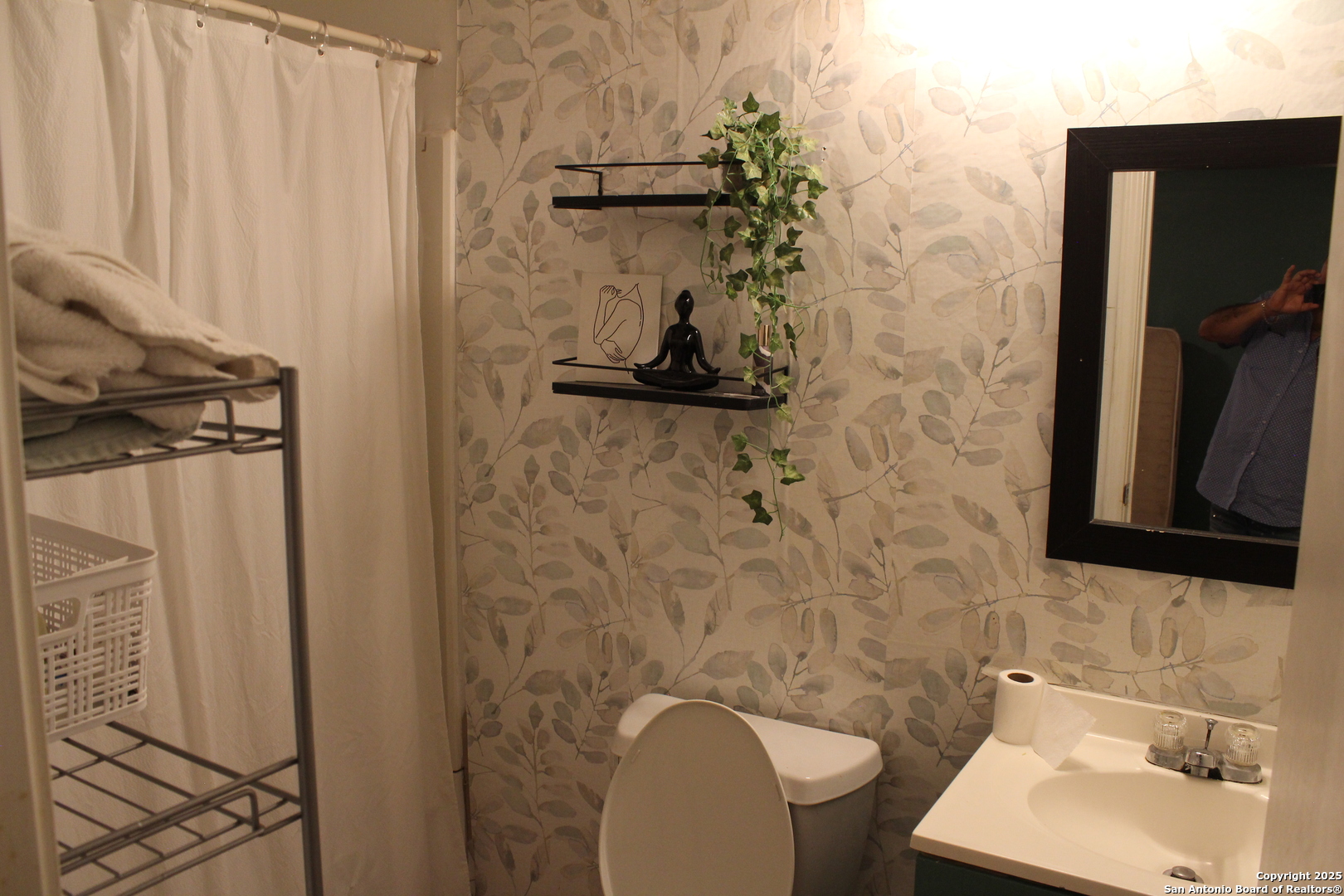406 County Road 6850, Unit 1 Lytle, TX 78052 - Photo 12 of 24 a bathroom with a sink and a mirror