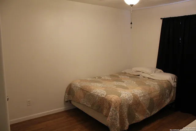 a bed sitting in a bedroom next to a window