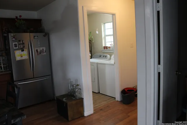 a room with wooden floor and a sink