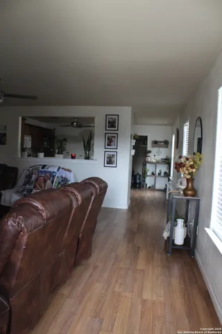 a bedroom with furniture and a wooden floor
